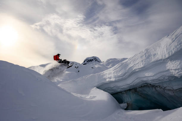 istock Backcountry snowmobiler jumps in front of ice cave 2165285928