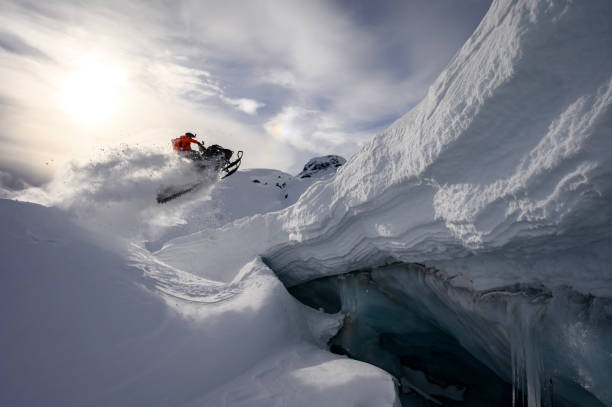 istock Backcountry snowmobiler jumps in front of ice cave 2165285931