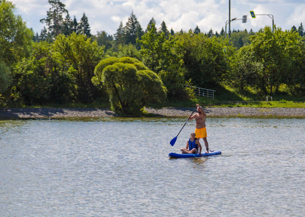 istock A father rides his son on a SUP board. 2165287364