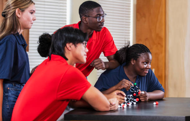 istock Four multiracial high school students in chemistry class 2165289368