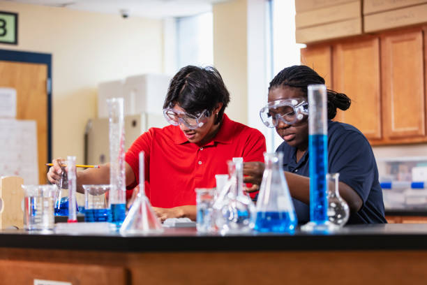 istock Two high school students work in chemistry lab together 2165289393