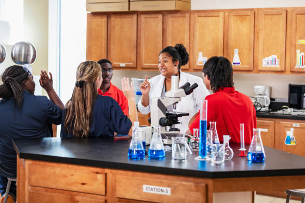 istock Chemistry teacher teaching high school students 2165289458
