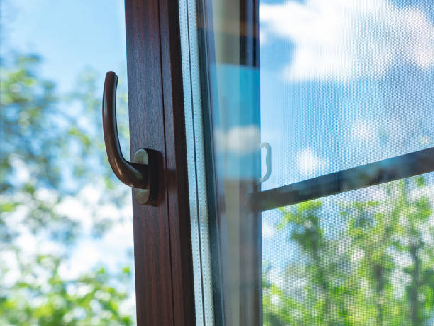 istock double-glazed windows, opening windows with brown frames and mosquito net, summer day 2165289550