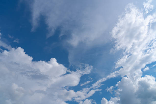 istock white fluffy clouds isolated on a black background 2165289592