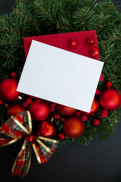 istock Greeting card with copy space mock up template white paper sheet on handmade Christmas wreath. Festive mood new year celebration. Postcard decoration decor 2165289761