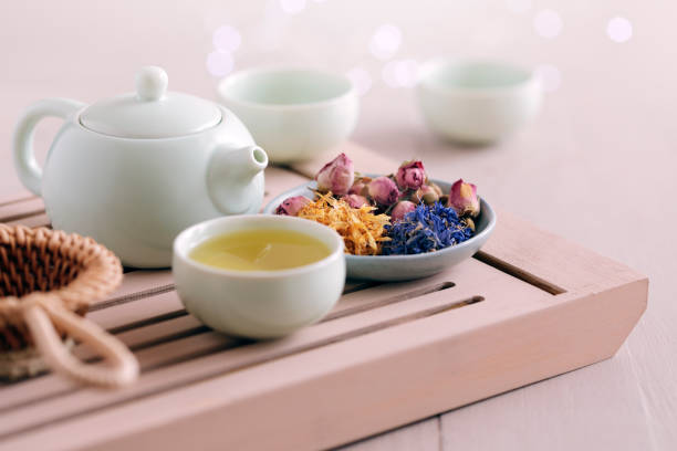 Colorful flower petals,buds with teapot and cups