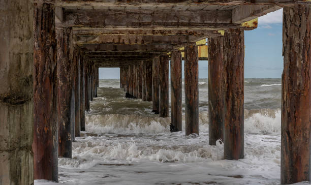 istock Aged Pier and Crashing Waves 2165292158