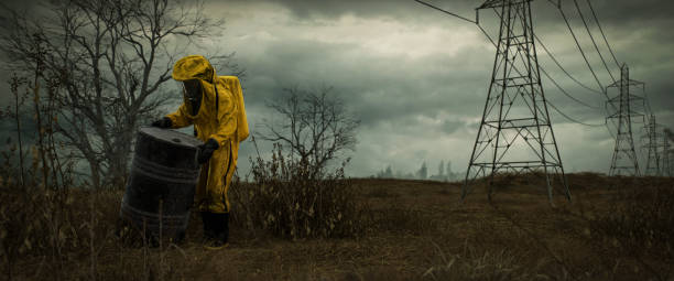 Digitally generated hazmat worker examining a barrel in a desolate post-apocalyptic landscape. The scene is marked by bleak skies, barren trees, and power lines, conveying a sense of isolation and danger. Ideal for themes of survival, contamination, and dystopian future.The scene was created in Autodesk® 3ds Max 2025 with V-Ray 6 and rendered with photorealistic shaders and lighting in Chaos® Vantage with some post-production added.