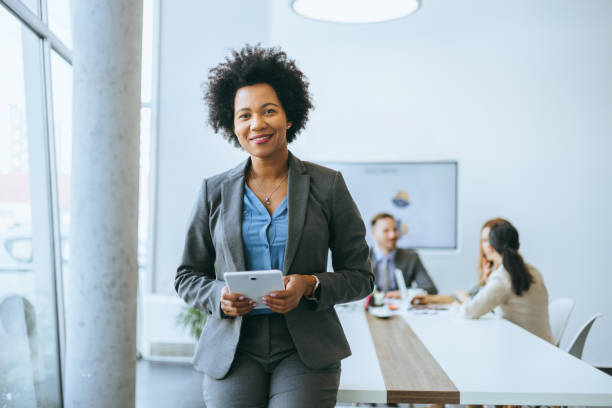 istock Smiling professional with digital tablet in office 2165292515