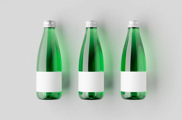 istock Small water bottle mockup with blank label. Green glass. 2165292825