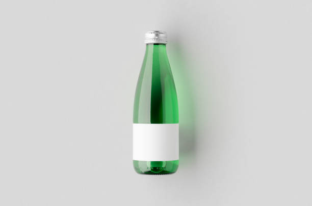 istock Small water bottle mockup with blank label. Green glass. 2165292829