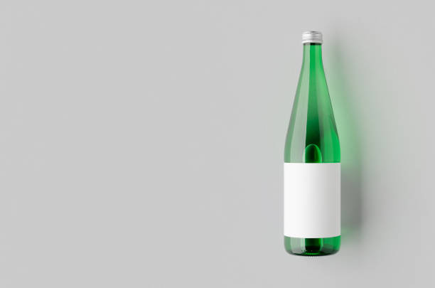 istock Green glass water bottle mockup with a blank label and copyspace. 2165292979