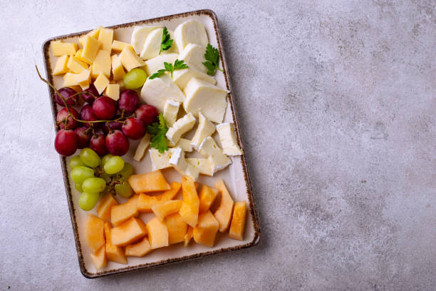 istock Cheese plate with different cheese, grapes and melon. 2165293240