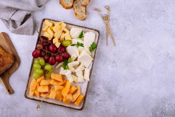 istock Cheese plate with different cheese, grapes and melon. 2165293249