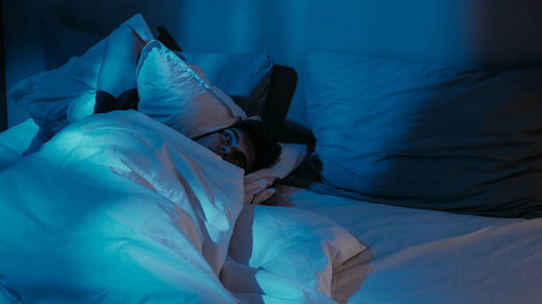 istock Night contemplation in Dimly Lit Room with Pillows 2165293391