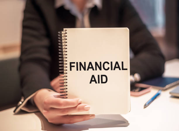istock Holding Financial Aid Handbook During a Consultation in an Office Setting 2165293681