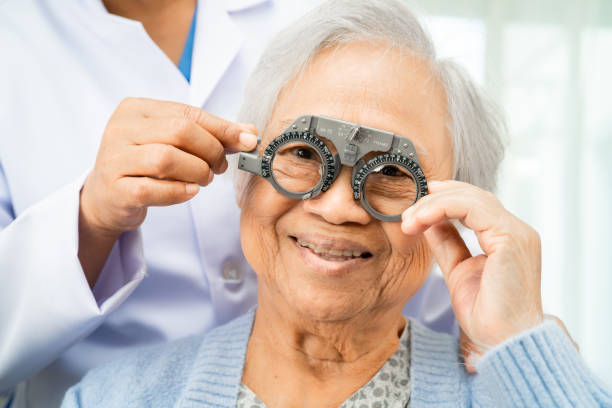 istock Optometrist checking Asian elderly woman ophthalmic vision eye test and using optical trial frame. 2165294015