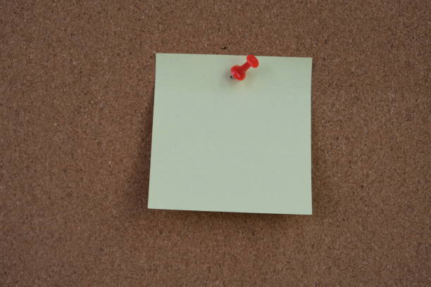 istock paper note reminder sticky notes pin paper on cork bulletin board. empty space for text. 2165294883