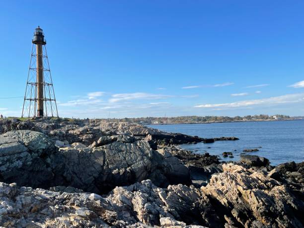 Skeletal Marblehead Light on the stony shore