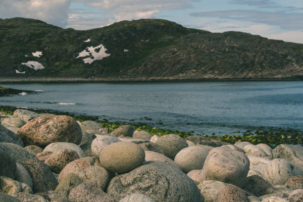 Serene Coastal Landscape with Rocky Beach and Distant Mountains, Teriberka, Murmansk district, Russia