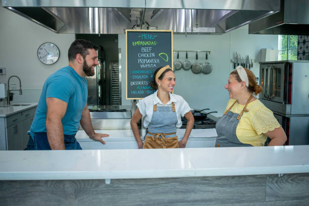 istock Three coworkers laugh in preparation for the store opening 2165303776