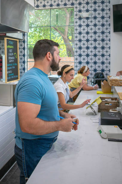 istock Three employees take orders during busy hours at pop up restaurants 2165303868