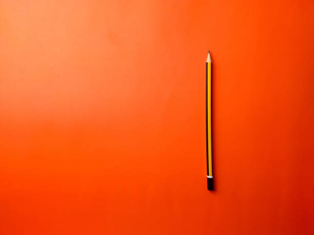 istock Top view yellow pencil on a orange background 2165303987