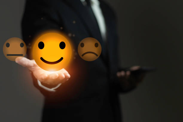 istock A man is holding a phone with a happy face on it 2165304193