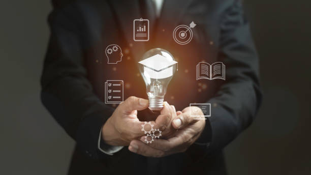 istock A man is holding a light bulb with a graduation cap on it 2165304204