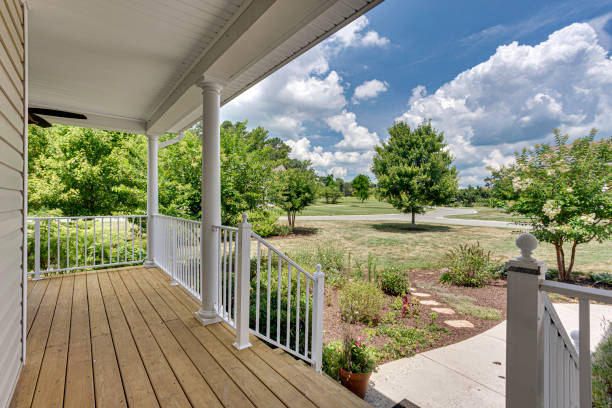 istock Cozy Front Porch With Wooden Decking And White Railing, Overlooks Greenery. 2165305281