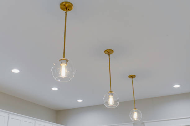 istock Kitchen Lighting Featuring Three Pendant Lights With Clear Glass Globes. 2165305926