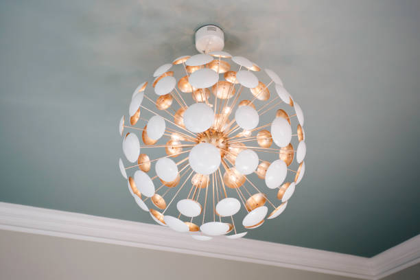 Modern Spherical Chandelier With White And Golden Elements On Ceiling.