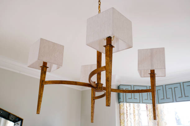 istock Rustic Chandelier With White Square Lampshades In A Bright Interior Room. 2165306108