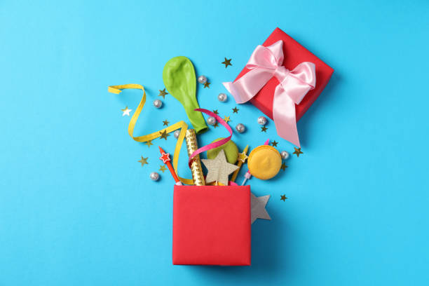 istock Gift box with Birthday accessories on blue background 2165306850