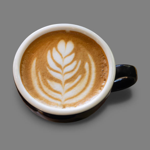 Close-up Latte art on coffee cup with shadow on isolated background. Focus on specific points and top view include clipping path.