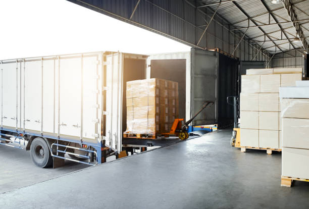 istock Bulk pallets of packaging boxes being loaded onto a container truck. distribution warehouse Container transport, supply chain, parcel delivery. Freight truck, logistics, transportation. 2165314754