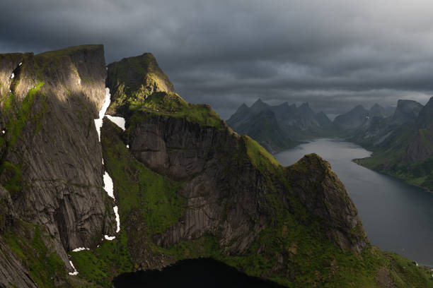 istock Sun beams illuminating a cliff on the Reinebringen summit 2165315012