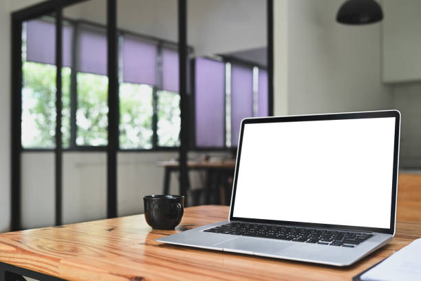 istock A laptop computer with white blank screen and cup of coffee on wooden table 2165315308