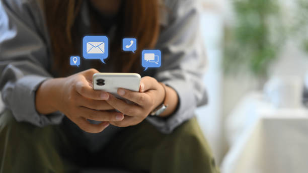istock Female hands using smartphone with notification icons. Communication and technology concept 2165315310