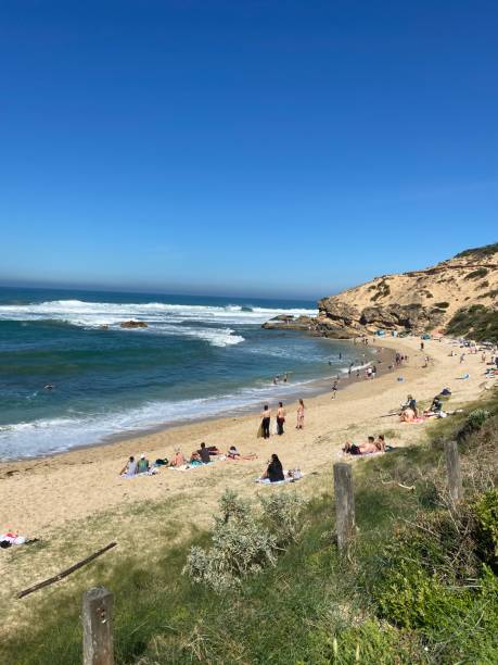 istock Ocean beach with people 2165316021