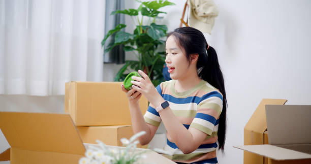 istock Young woman was packing things into boxes for her move. 2165316519