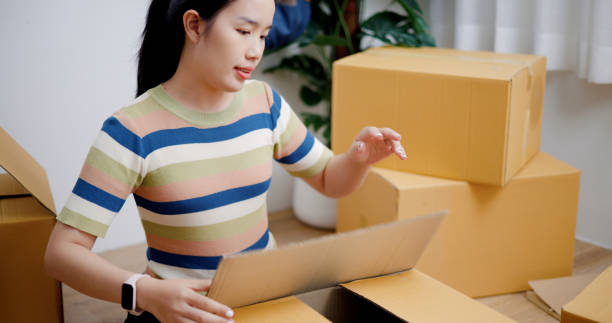 istock Young woman closes a box that has already been packed. 2165317309