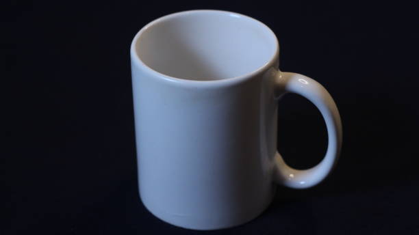 istock image of a white glass on a black background 2165318251