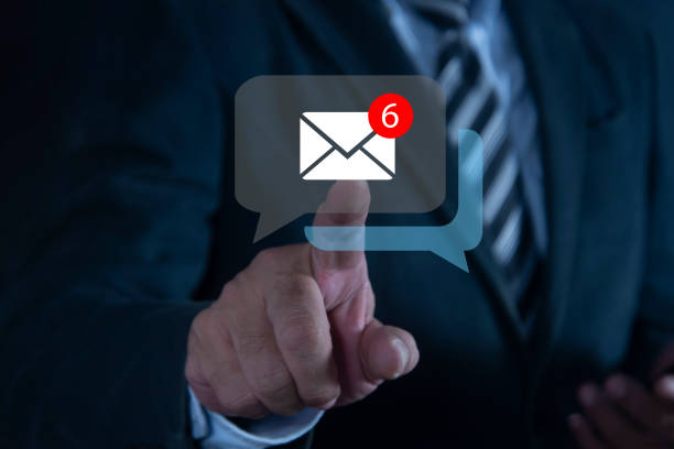 Businessman hand touching email on virtual screen. The inbox receives electronic message notifications. New email notification concept for business email communication and digital marketing.
