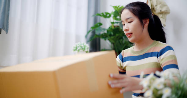 istock Young woman closes a box that has already been packed. 2165321163