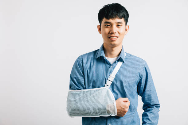 istock happy Asian man wears arm support in studio shot isolated 2165322321