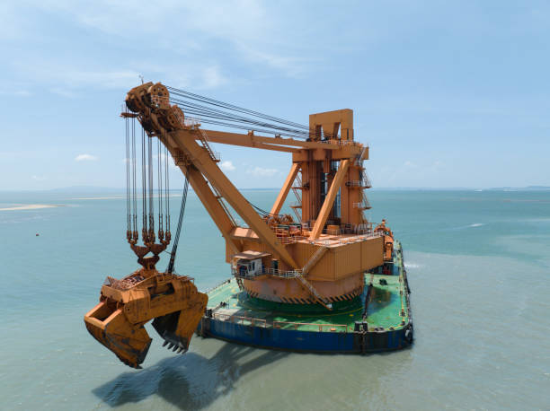 A huge hopper dredger vessel in action, dredging sediment from the bottom of the harbor.