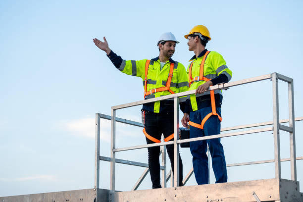 istock Diverse male technicians working to maintenance outdoors warehouse. Innovation engineer men wearing safety gear, work to develop environmental renewable clean energy outside storehouse factory plant. 2165324965