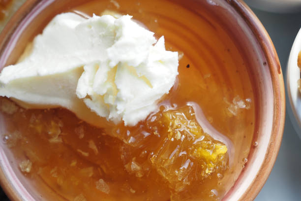 butter cream and honey in a bowl on table