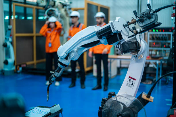 istock A group of Robotics engineers working with Programming and Manipulating Robot Hand, Industrial Robotics Design, High Tech Facility, Modern Machine Learning. Mass Production Automatics. 2165325166